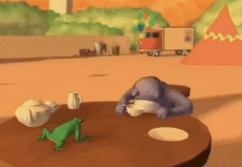 a frog is sitting on a table next to a purple gorilla drinking a cup of tea .
