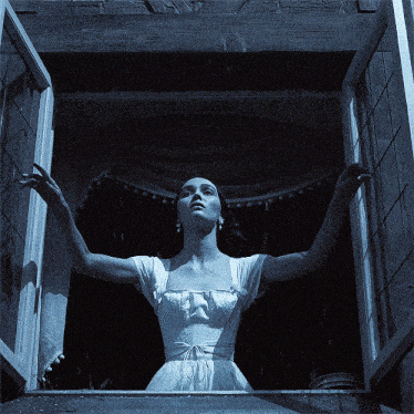 a woman in a white dress is looking out a window at the rain