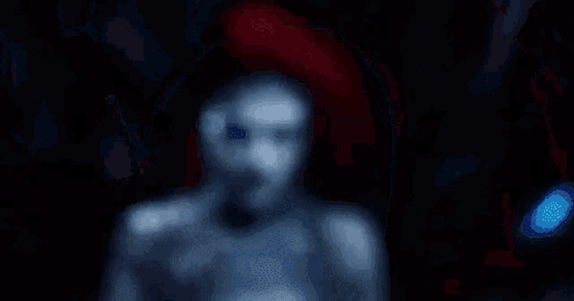a close up of a woman 's face with glowing blue eyes .