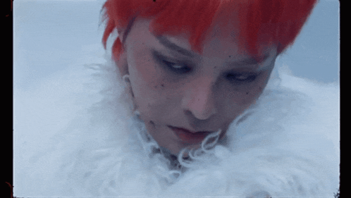 a close up of a person with red hair and white fur