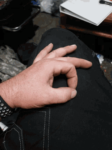 a man 's hand is making an ok sign