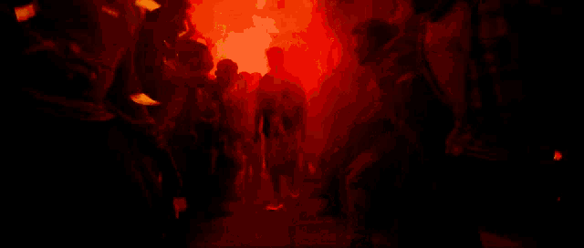 a man is standing in front of a crowd of people watching fireworks