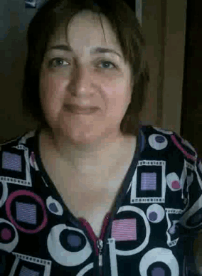 a close up of a woman 's face wearing a black and pink polka dot shirt