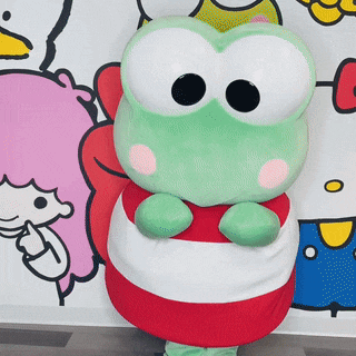 a stuffed frog with big eyes and a red and white striped shirt
