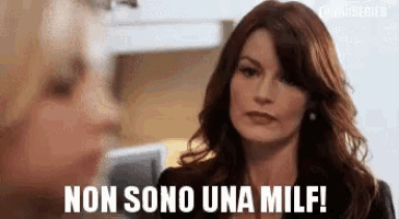 a woman is talking to another woman in a kitchen and says non sono una milf .