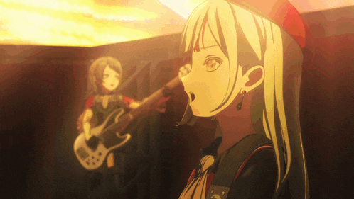 a girl singing while another girl plays guitar