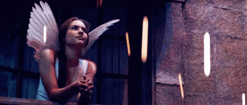 a woman with angel wings is standing on a balcony .