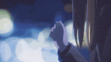 a close up of a person 's hand against a dark background