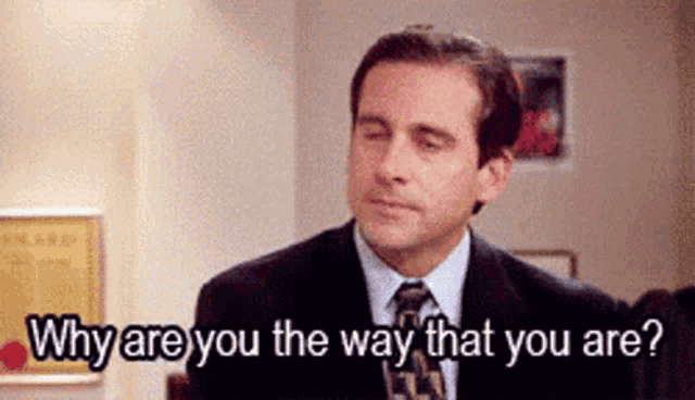 a man in a suit and tie is talking to another man and asking why are you the way that you are ?