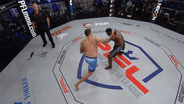 two men are fighting in a ring with a pfl logo on the floor