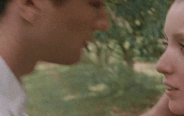 a man and a woman are looking at each other