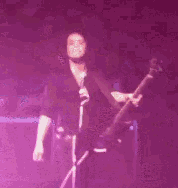 a blurry picture of a person playing a guitar on a stage