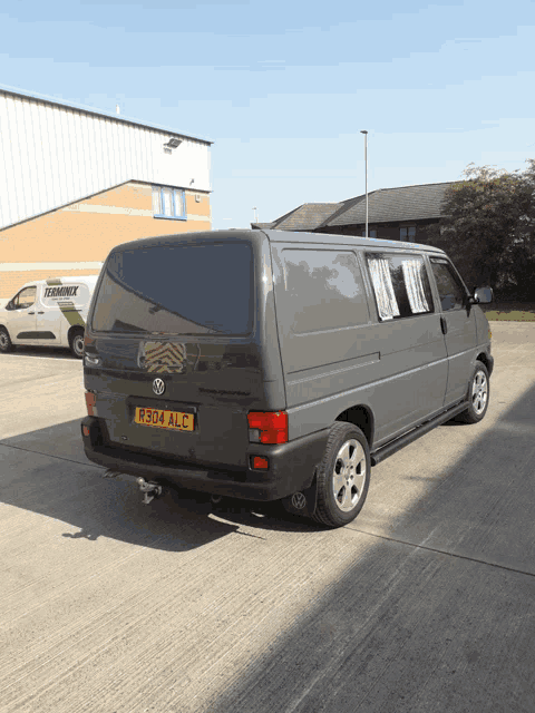 a volkswagen van has a license plate that says r284alc