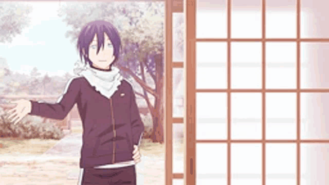 a man with purple hair is standing in front of a window .
