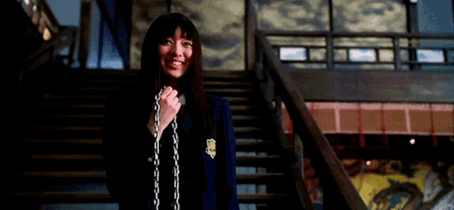 a girl in a school uniform is holding a chain in her hand and says " you call that begging "