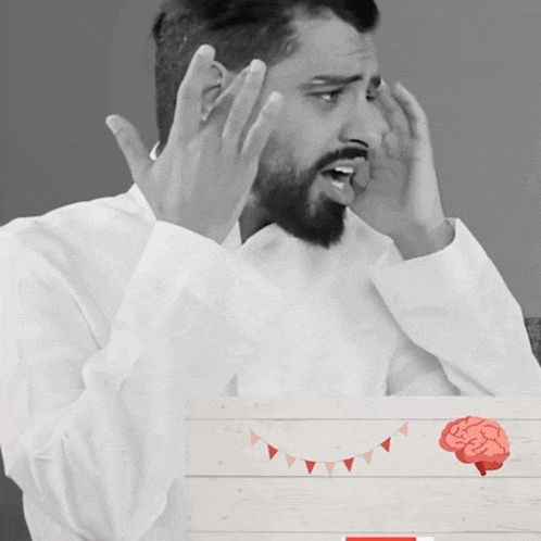 a black and white photo of a man with his hands on his head