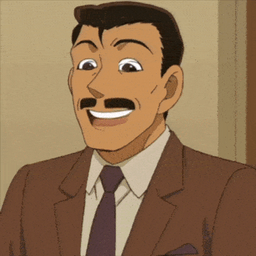 a man in a suit and tie is laughing with his tongue out