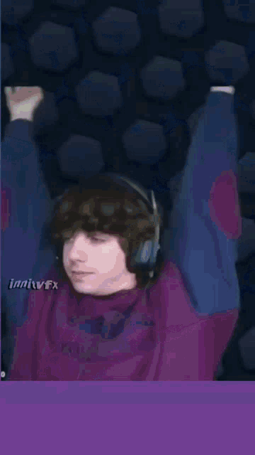 a man in a purple shirt is playing a video game with a snake in the background