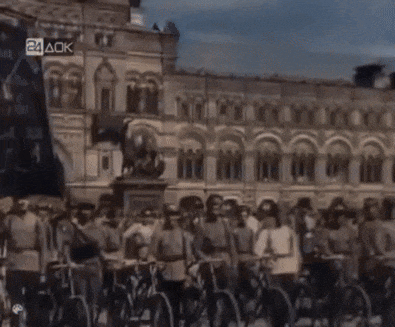 a group of people riding bicycles in front of a building that says 24ack