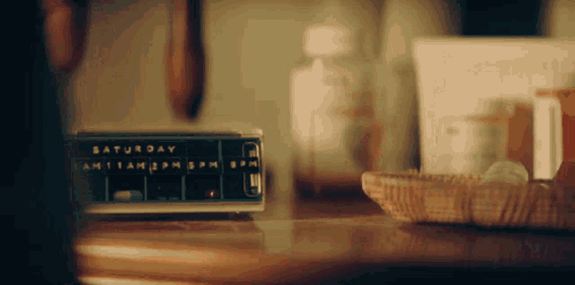 a clock on a table shows the time as saturday