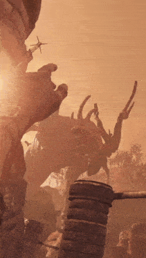 a person is looking up at a statue of a monster