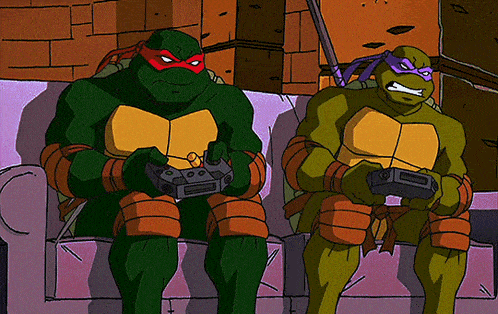 two teenage mutant ninja turtles are sitting on a couch playing a video game