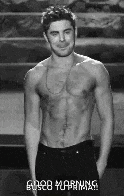 a shirtless man is standing on a stage with his hands in his pockets and says good morning .