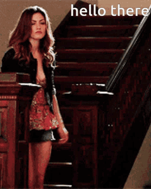a woman is standing on a set of stairs with the words hello there written above her