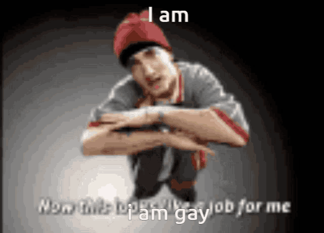 a man in a red hat is squatting down with the words i am now this is a gay job for me below him