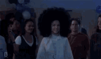 a woman with a big afro says hi everybody it 's the new jan brady .