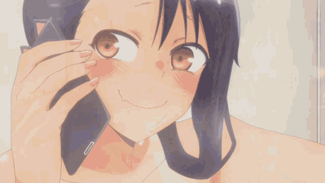a girl is talking on a cell phone with a cat ear on it