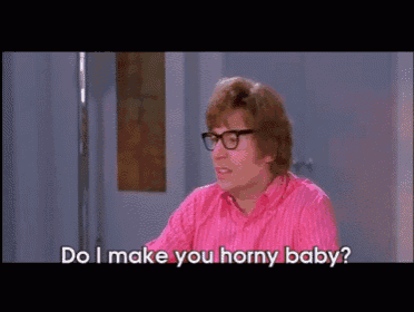 a man wearing glasses and a pink shirt is asking do i make you horny baby