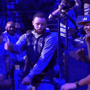a man is dancing in front of a crowd at a concert