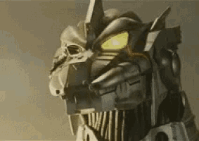 a close up of a robot with glowing yellow eyes .