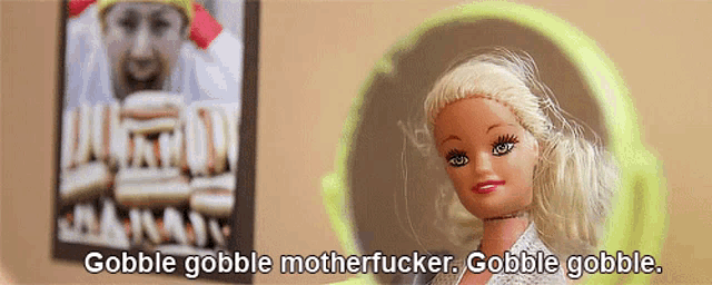 a barbie doll says gobble gobble motherfucker in front of a picture