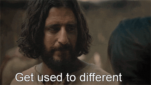 a man with a beard is talking to a woman with the words get used to different written below him