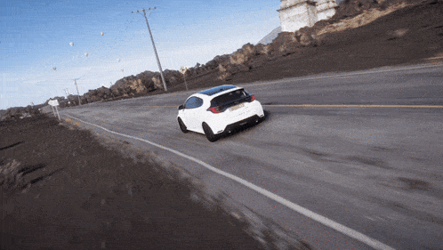 a white car is driving down a road with a sign that says ' sydney ' on it
