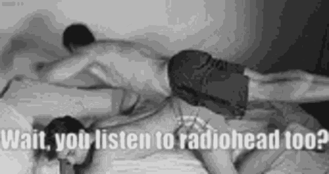 a man is laying on top of a woman on a bed and says `` wait , you listen to radiohead too ? ''