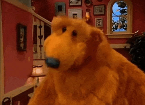 a close up of a teddy bear with a blue nose .