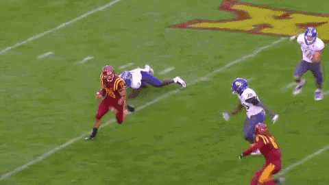 a football player wearing a red jersey with the number 19 on it is running on the field .