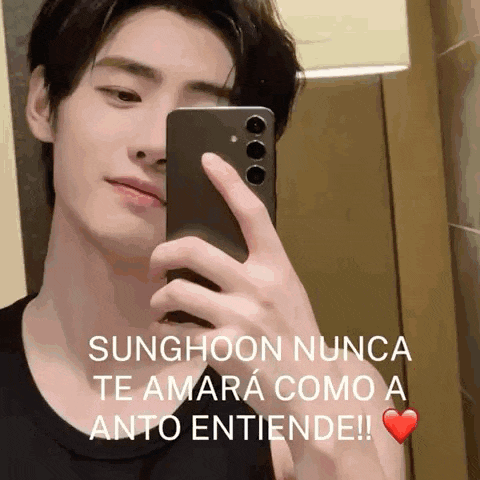 a young man is taking a picture of himself in a mirror with a heart in the corner