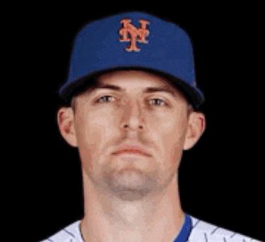 a baseball player wearing a blue hat with the letter n on it is looking at the camera .