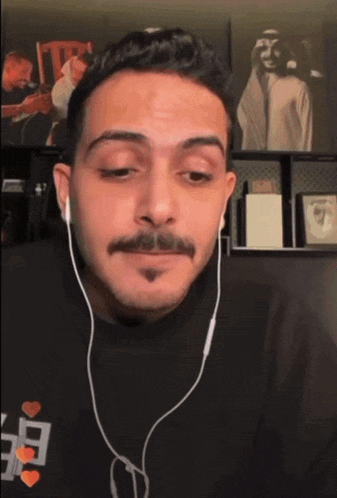 a man with a mustache wearing headphones with jaco written on the screen