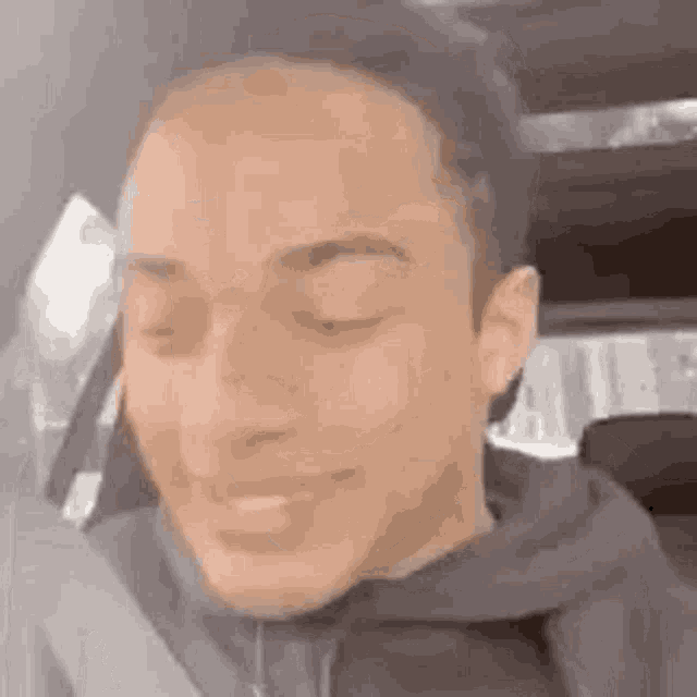 a man is smiling while sitting in the back seat of a car .