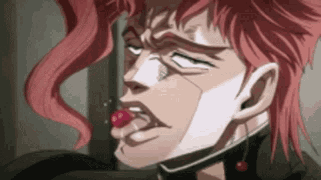 a close up of a person eating a cherry with their tongue out .