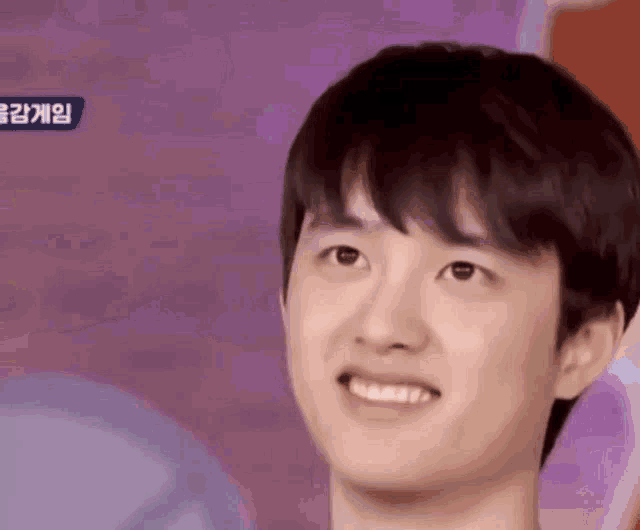 a close up of a young man 's face smiling .