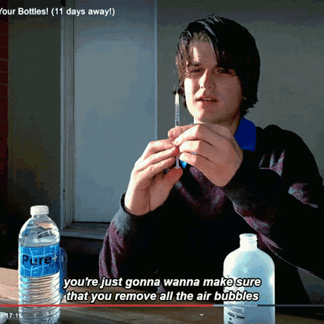 a man holding a syringe next to a bottle of pure