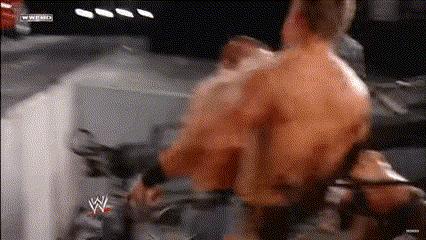 a man in a wrestling ring with a w logo on the bottom right