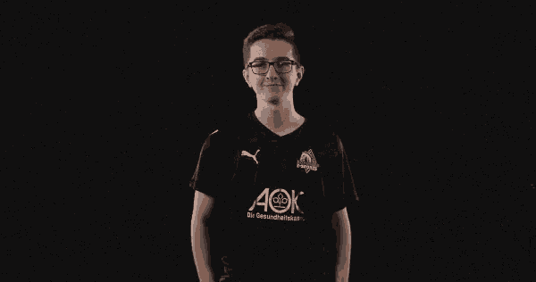 a young man wearing a black shirt with aok written on it