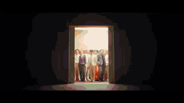 a group of men standing next to each other in a room .